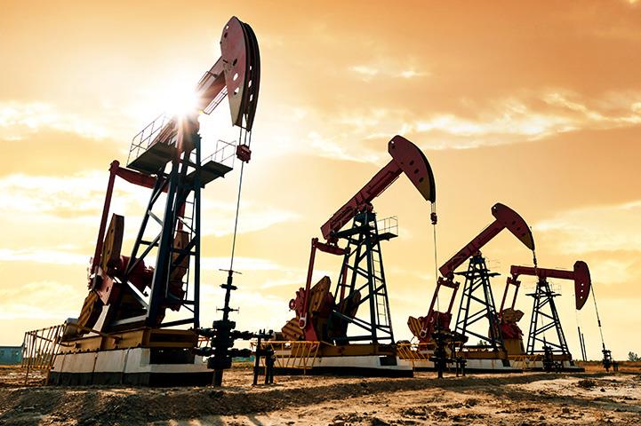 four oil pumps operating under sunrise sky