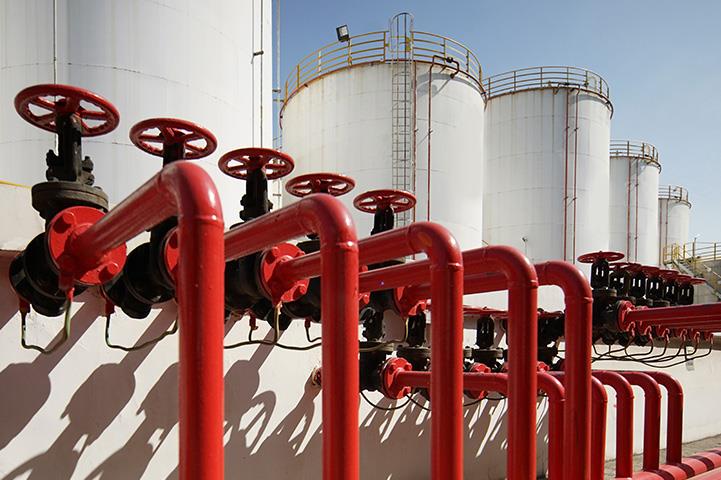 oil refinery with red valve of oil pipeline