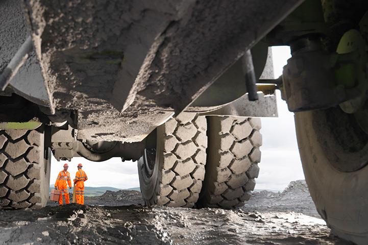 view beneath truck with orange safety workers