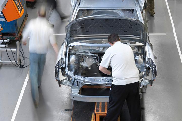 view of people working in car assembly line plant